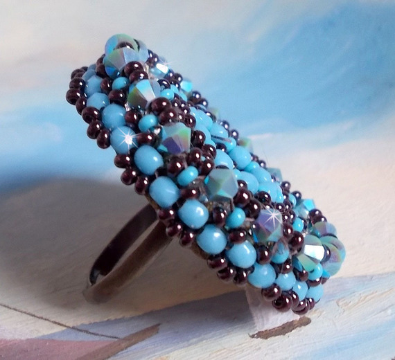 Naïade ring brodert med en turkisblå harpiks og krystall cabochon, et vakkert lysspill.