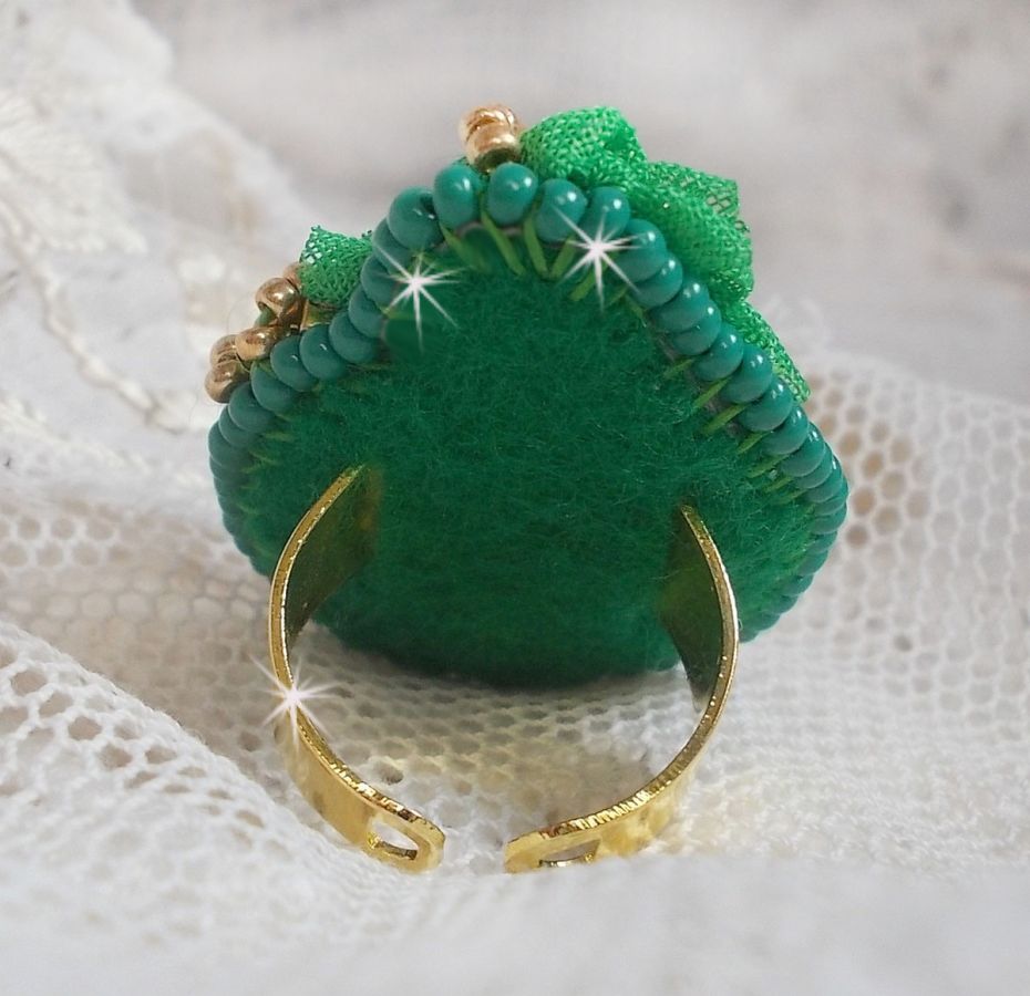Vakker smaragdring med en keramisk cabochon laget av en gul og grønn rose
