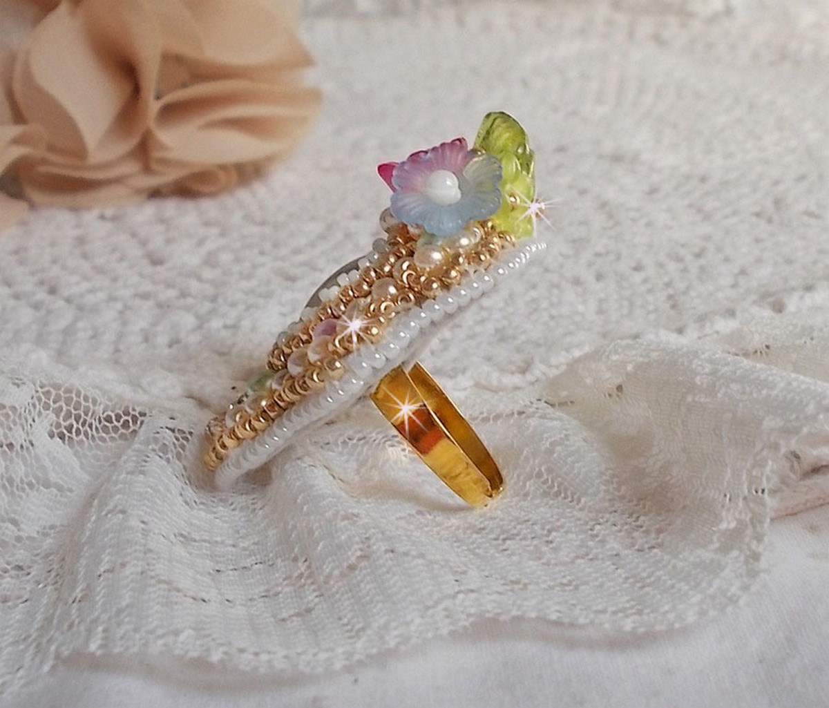 Envolée Fleurie ring brodert med en harpiks cabochon av Lucite blomster, perle perler og frø perler