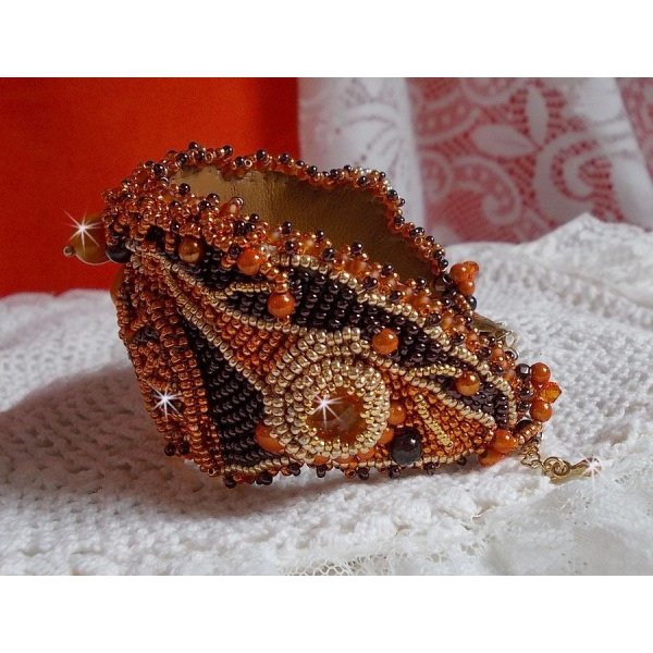 Dame i oransje mansjettarmbånd Haute-Couture brodert med Swarovski-krystaller og Miyuki frøperler.