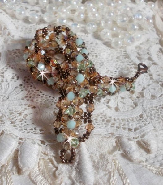 Vannliljearmb&aring;nd, en gr&oslash;nn og gull refleksjon med Swarovski krystall snurretopper og bohemske glassfasetter