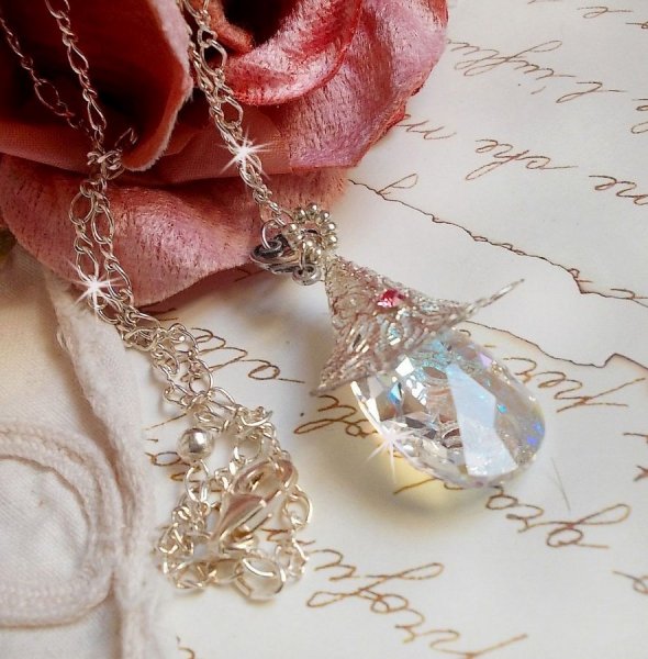 S&oslash;lvblomsterhalskjede med et vakkert Swarovskikrystallanheng, en s&oslash;lv hjerteformet innsats med kjede, ringer, l&aring;s og forlengelseskjede i s&oslash;lv 925/1000