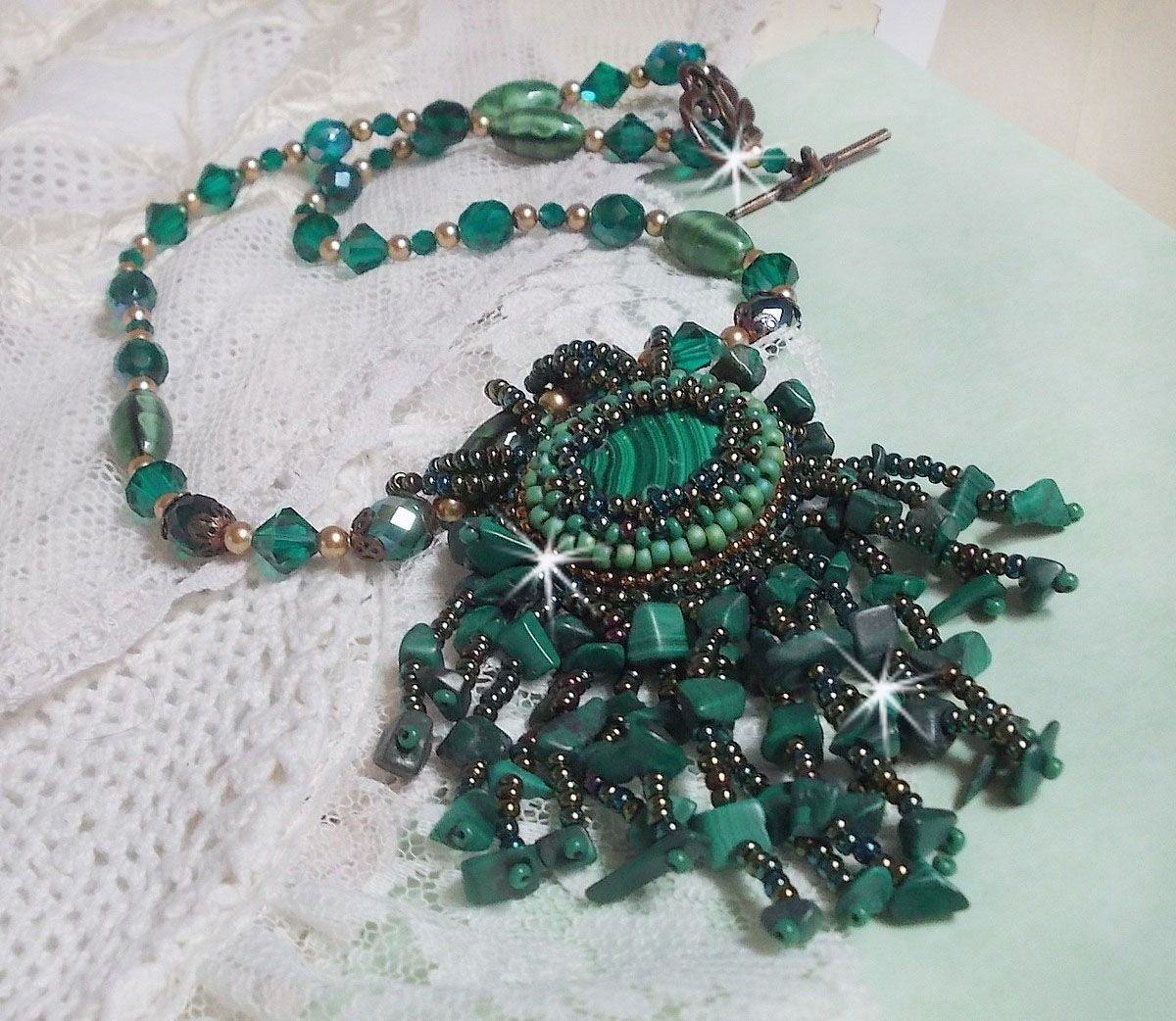 Smaragdgrønt anheng brodert med naturlig malakitt cabochon og chips, krystaller, fasetter og perler
